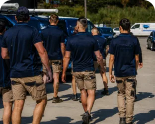Plumbers walking to their service vans on a Lane Cove job