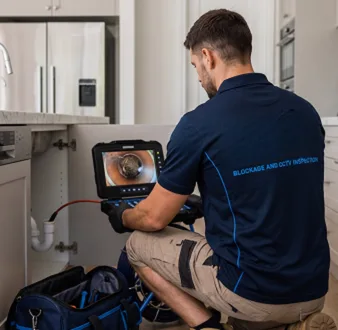 Clearing a blocked sink at a Lane Cove property